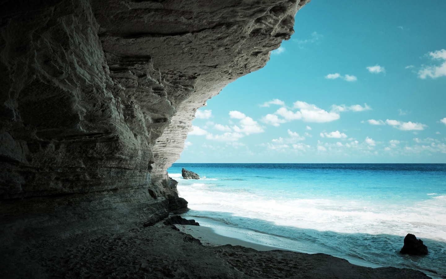 Beach cave with blue water and sky
