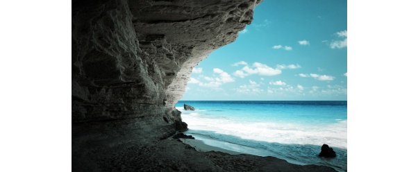 Beach cave with blue water and sky (click to view)